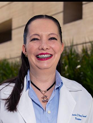 Es la foto de perfil de una pediatra en Ciudad de México de Hospital Angeles. La doctora viste una blusa rosa con un moño en el cuello, su maquillaje es de color rosado y tiene arracadas rose golde.