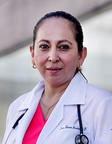 Es la foto de perfil de una ginecóloga y obstetra en Ciudad de México de Hospital Angeles. La doctora tiene una bata blanca con una blusa rosa fosforescente. Usa joyería dorada, es de tez blanca y cabello oscuro.