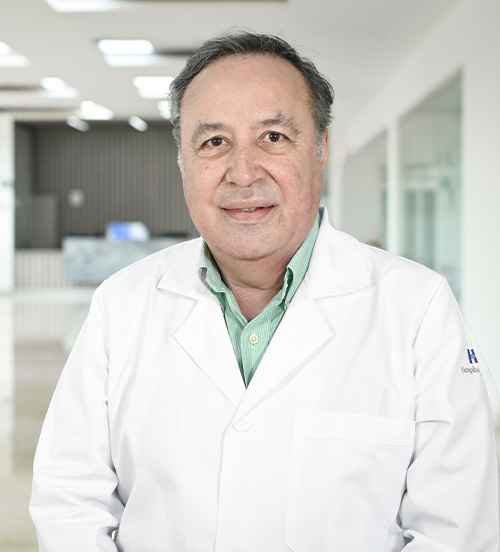 This is the profile photo of an obstetrician-gynecologist Tampico  Hospital Angeles Tampico Tampico . He is wearing a black jacket, a white shirt, and a blue tie. He has gray hair. His arms are crossed, and he is smiling.