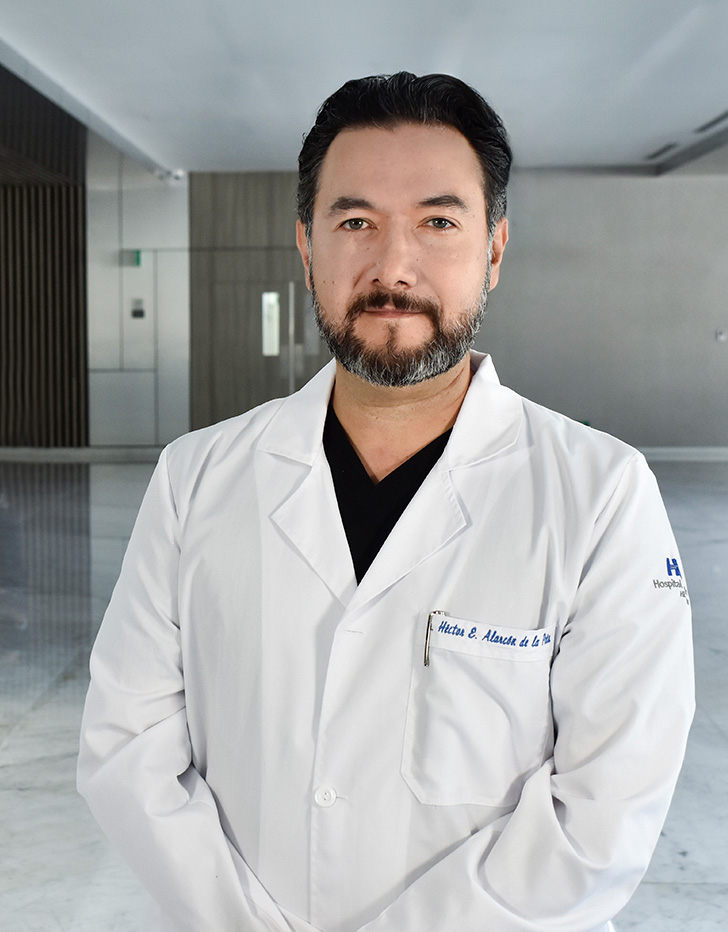 Es la foto de perfil de un anestesiólogo en Querétaro de Hospital Angeles Centro Sur. Viste un traje negro con cuadros azul marino, una camisa blanca, tiene barba y ojos verdes.