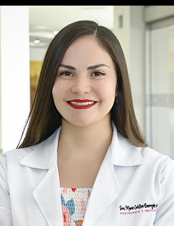 Es la foto de perfil de un ginecólogo y obstetra en Ciudad Juárez de Hospital Angeles Ciudad Juárez. Trae una bata blanca con una blusa blanca con colores vibrantes, cabello lacio y largo.