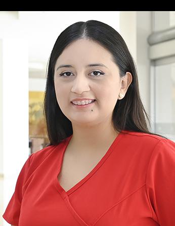 Es la foto de perfil de un neurólogo pediátrico en Ciudad Juárez de Hospital Angeles Ciudad Juárez. Utiliza un uniforme rojo y tiene el cabello largo y lacio.