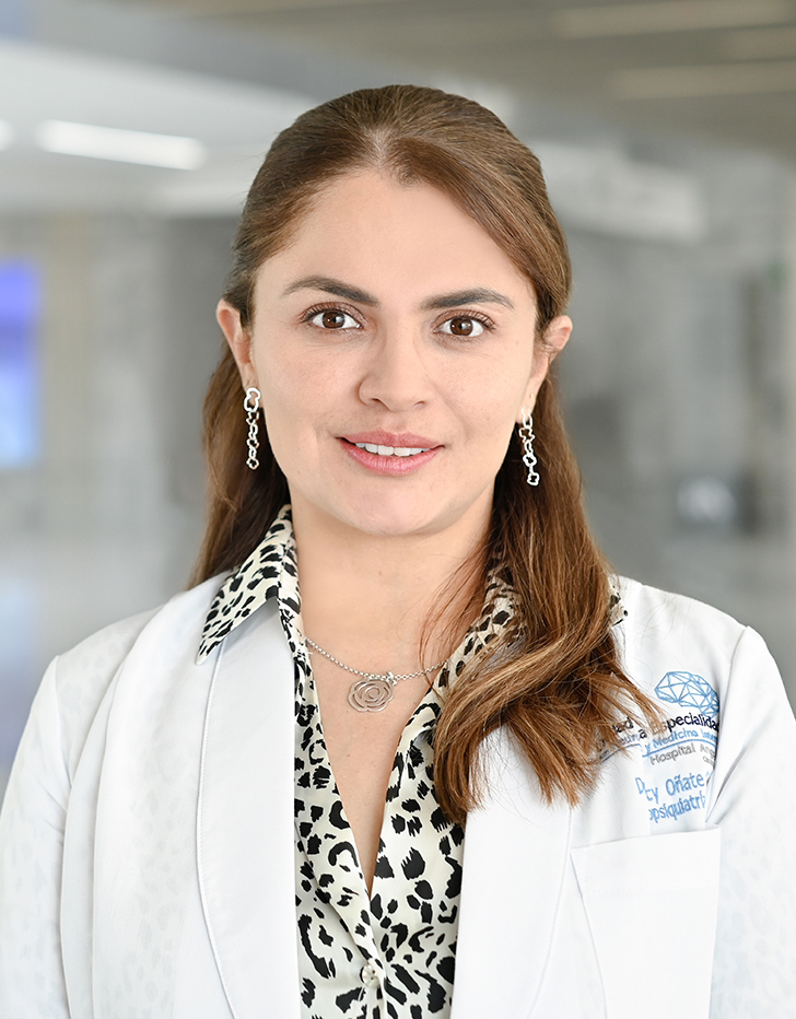 Es la foto de perfil de una psiquiatra en Querétaro de Hospital Angeles Centro Sur. La doctora tiene una bata blanca una blusa con lunares negros aretes largos y cabello largo.