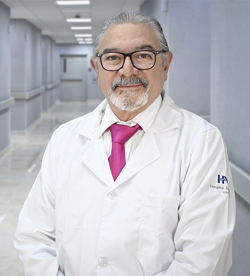 This is the profile photo of a urologist León  Hospital Angeles León in León . He has a mustache and wears black glasses and a red tie.